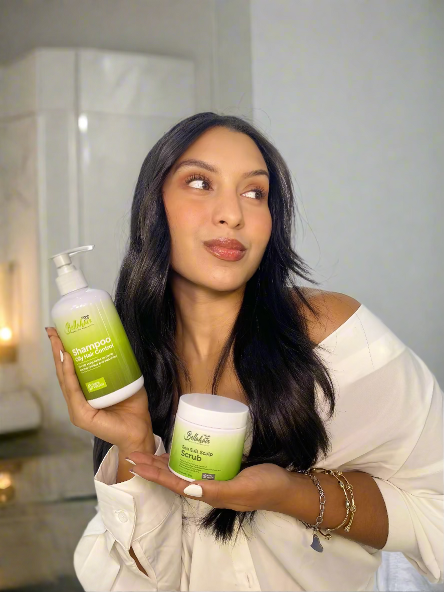 Woman holding a bottle and a jar of hair care product Bellahair 