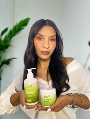 Woman holding two bottles of Bellahair products 